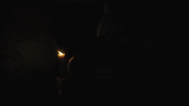 Horror - girl with a candle in a dark basement — Stock Video