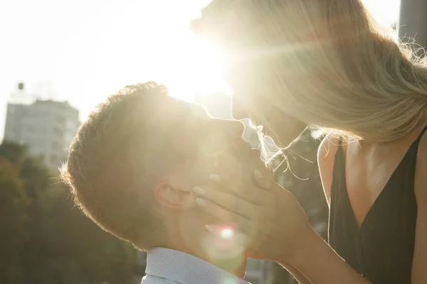Le couple embrasse, et entre eux les rayons du soleil, le soleil, la lumière. attraction entre un homme et une femme. baiser au soleil. embrasser le soleil. entre nous est le soleil . — Photo