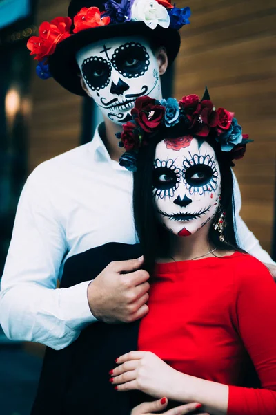 A couple, wearing skull make-up for. All souls day. Boy and girl sugar ...