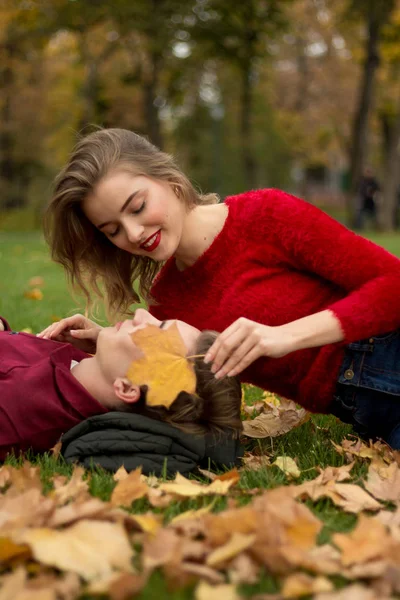 Couple Lying Green Grass Yellow Maple Leaves Faces Close Each — Stock Photo, Image