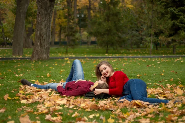 Couple Lying Green Grass Yellow Maple Leaves Faces Close Each — Stock Photo, Image