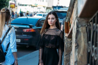 bir kız portresi esmer, siyah elbiseli, Arch, şehir. poz, yürüyüş. Kalabalıkta, yalnız loneliness.sad