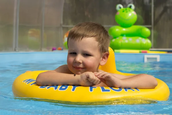 Χαριτωμένο και αστείο μικρό κορίτσι στην πισίνα, κολύμπι στο φουσκωτό δαχτυλίδι, αντίληψη του τρόπου ζωής. Το φουσκωτό κύκλο. Το καλοκαίρι. Pool.Cricket που σώζει από το νερό — Φωτογραφία Αρχείου