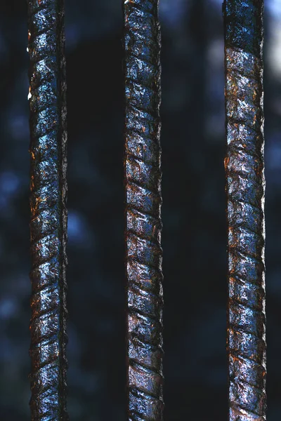 Metal bars in wet and rusty condition. Close up of a jail cells iron bars. Way out to freedom concept. Steel Bars with rust stacked for construction or metallurgical objects for general use.