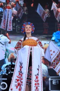 Beautiful Ukrainian dancing groups from United States and Canada perform at Montreal Ukrainian Festival. Young dancers in traditional costumes dancing on stage during the Ukrainian national holiday. clipart