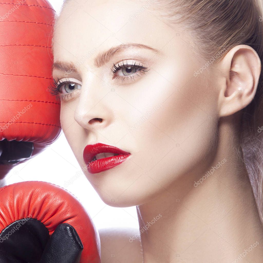 Young woman with red lips makeup and boxing-gloves on white background