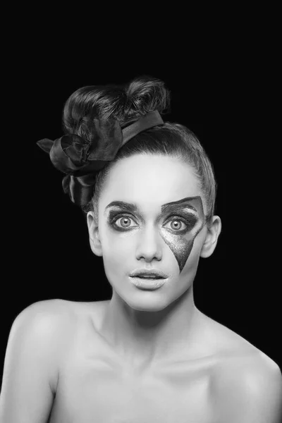 portrait of young woman with extraordinary makeup on black background