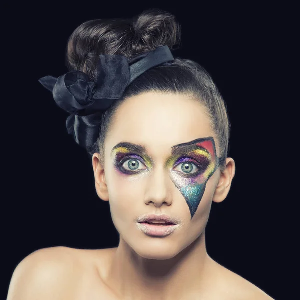 portrait of young woman with extraordinary makeup on black background