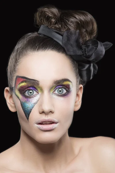 portrait of young woman with extraordinary makeup on black background