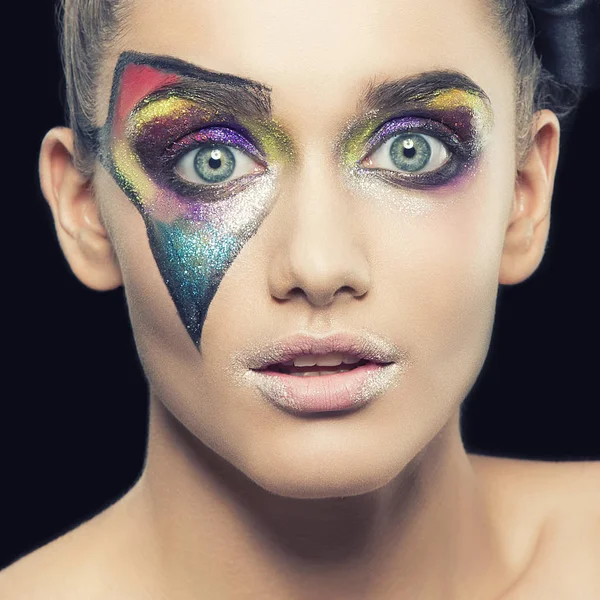 portrait of young woman with extraordinary makeup on black background