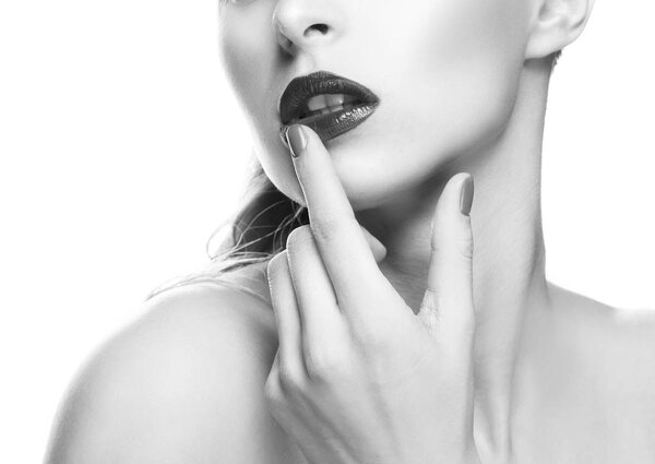 Cropped portrait of woman with dark lips and nail polish