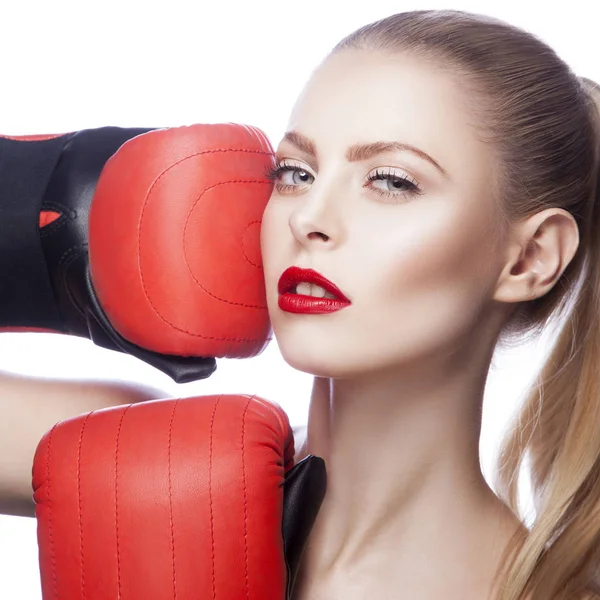 Fashion model with red lips makeup and boxing-gloves on white background