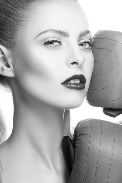 Fashion model with dark lips and boxing-gloves on white background