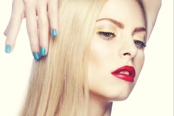 Portrait of woman with modern yellow eyeliner and red lips