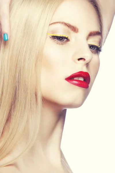 Portrait of woman with modern yellow eyeliner and red lips