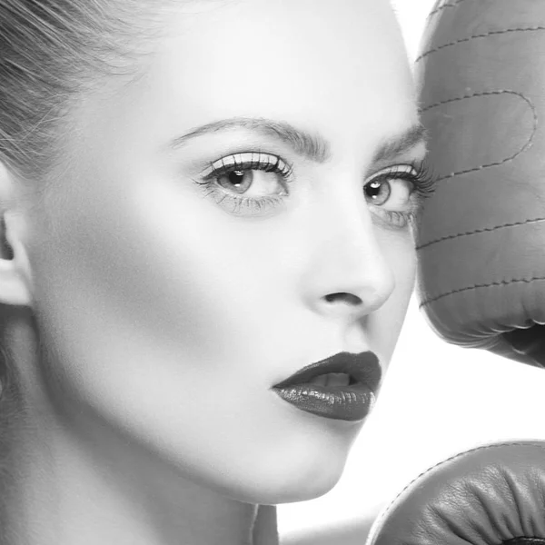 Fashion model with dark lips and boxing-gloves on white background