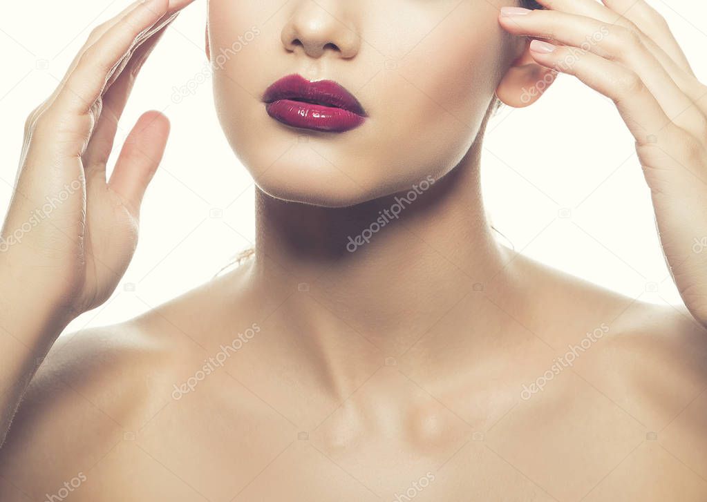 Cropped portrait of young woman with fashionable dark lips on white background