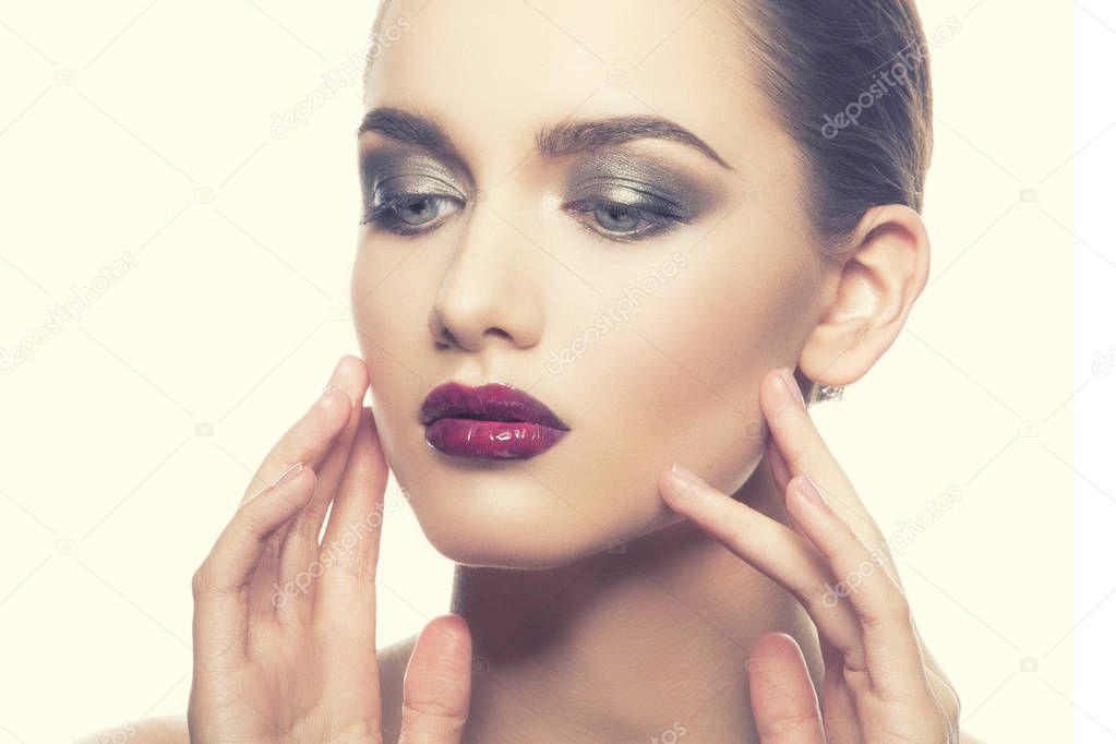 portrait of young woman with dark lips on white background