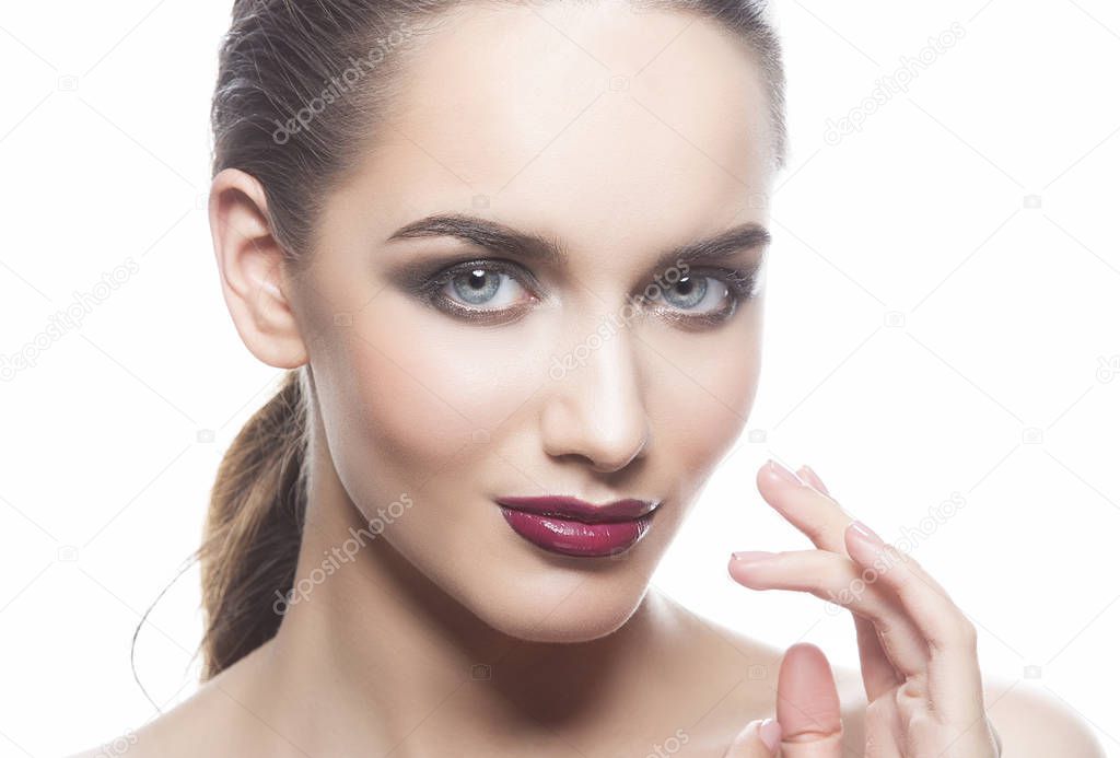 portrait of young woman with dark lips on white background