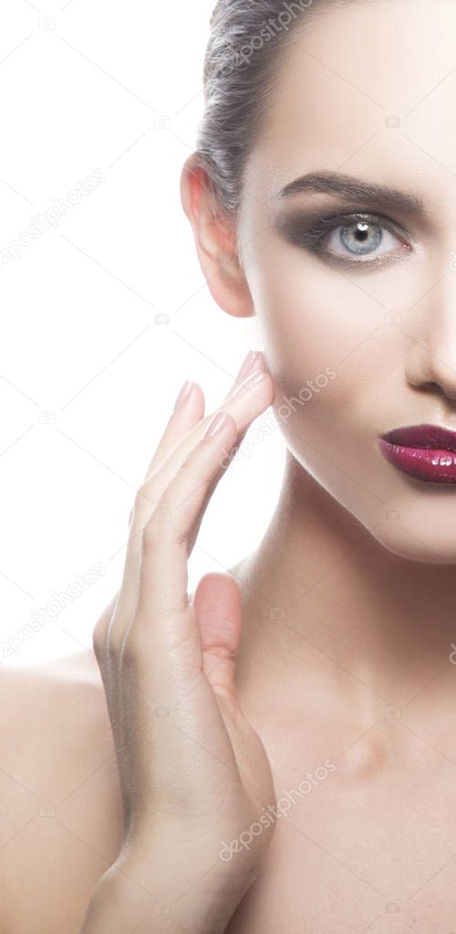 Cropped portrait of young woman with dark lips on white background