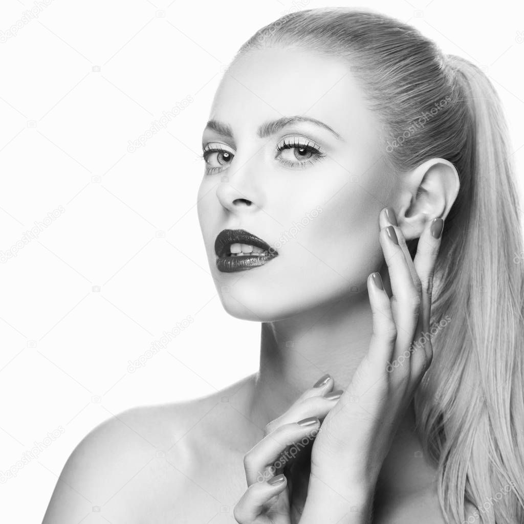 Portrait of woman with dark lips and nail polish on white background