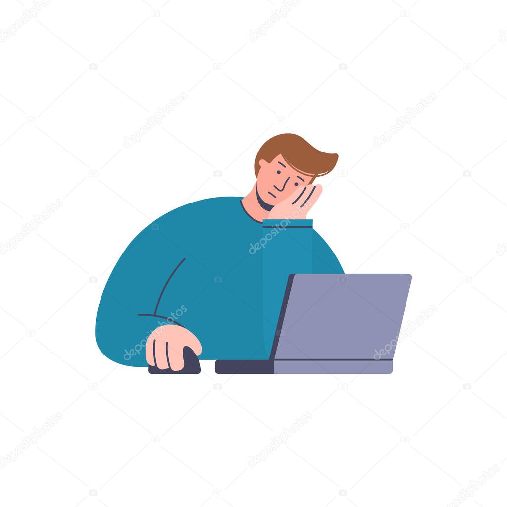 Young depressed and tired businessman working on the computer. Man sitting in front of the computer and his hand propping up head. Frustrated person doesn t want to work. Bored look. Wasting time concept.