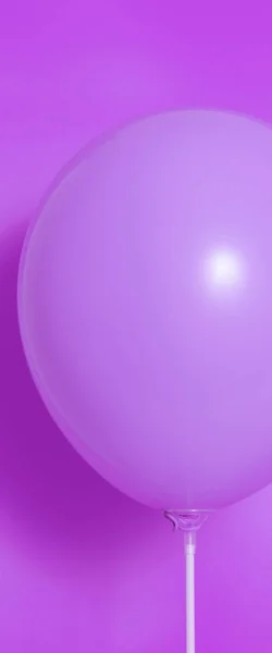 Purple balloon on a purple background with shadow. Side glare