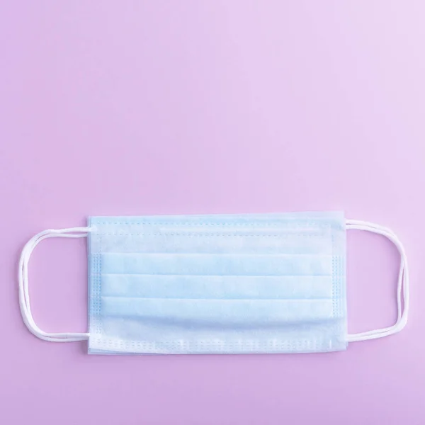 Medical mask surgical protective virus, flu, disease, textile filter. Isolated on a lilac background.