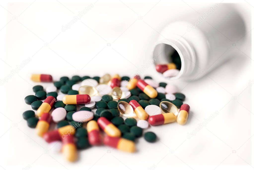 Colorful medical pills isolated on white background. Global healthcare concept. Antibiotics drug resistance.