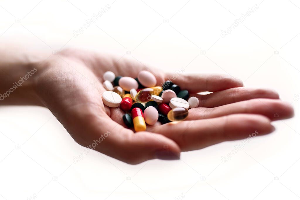 Close-up view of capsule in woman's hand. Pharmaceutical industry