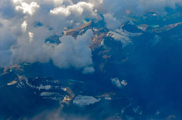 The Mountains and clouds above the Canadian Rocky Mountains from the airplane