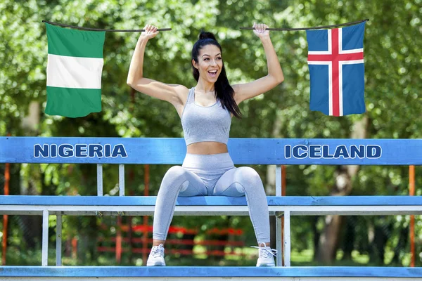Nijerya ve güneşli gün boyunca güzel seksi kız tarafından tutulan İzlanda bayrakları