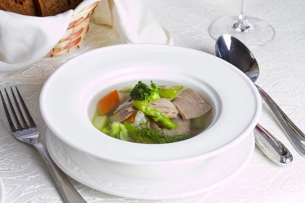Light summer soup with rabbit meat pieces