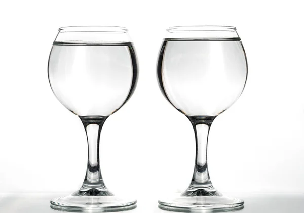 Due Bicchieri Rotondi Vuoti Pieni Con Onde Liquido Sfondo Bianco — Foto Stock
