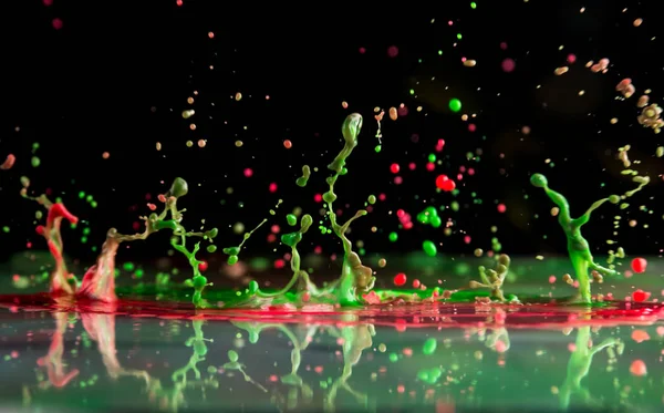 Bursts and splashes from falling paints of different colors