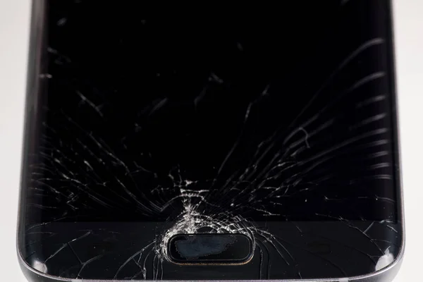 Broken smartphone screen, cracks and shattered glass under various eels