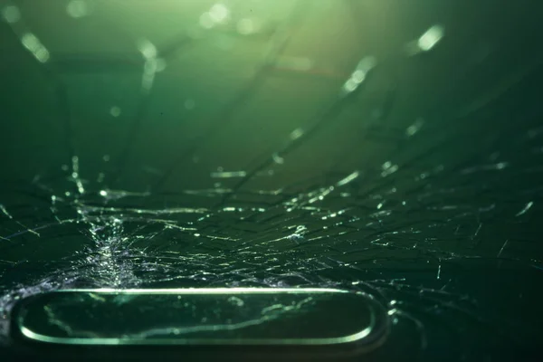 Broken smartphone screen, cracks and shattered glass under various eels