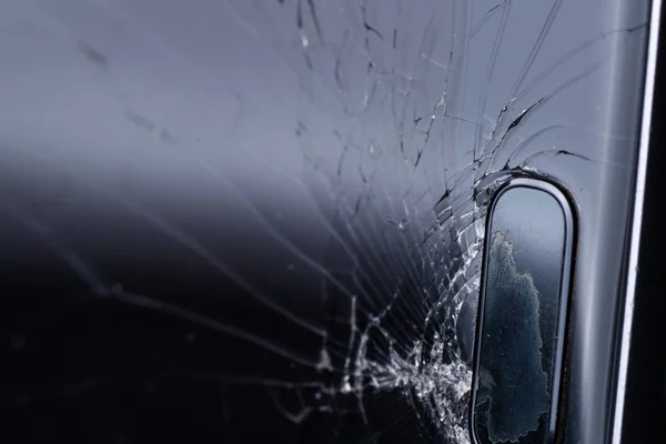 Broken smartphone screen, cracks and shattered glass under various eels