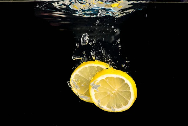 Slices Lemon Thrown Water Black Background — Stock Photo, Image