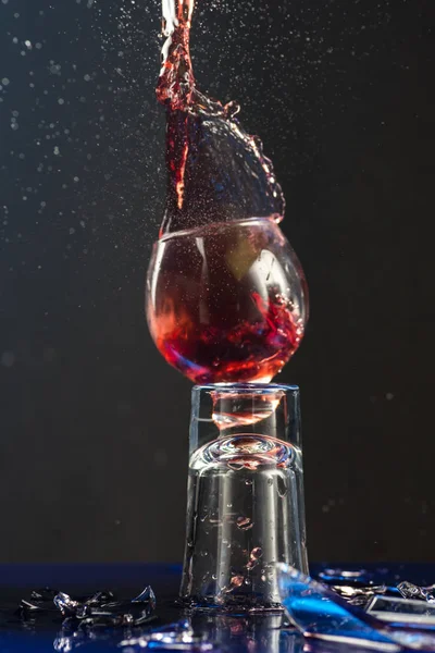 stock image Two small glasses of wine are beaten each other on the shards