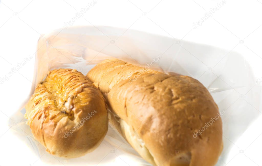 Food, packaging, transparent bag with loaf, rolls and bread inside