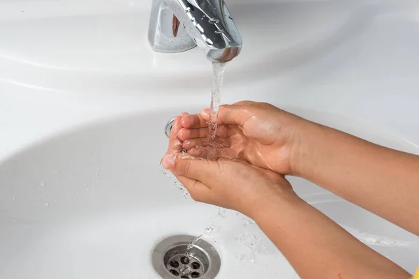 washing hands with soap on a white sink background, male hand or children's hands