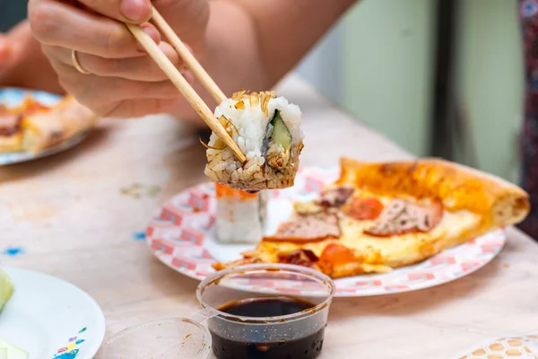 sushi and rolls with home delivery, eat at the table against the background of food
