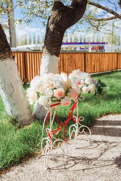 Beautiful coasters with a bouquet of flowers and ribbons. Decor for the wedding ceremony. Closeup.