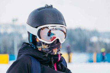 Portrait of woman snowboarder in helmet and goggles clipart
