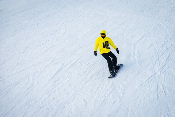 sports man snowboarding on snowy slope