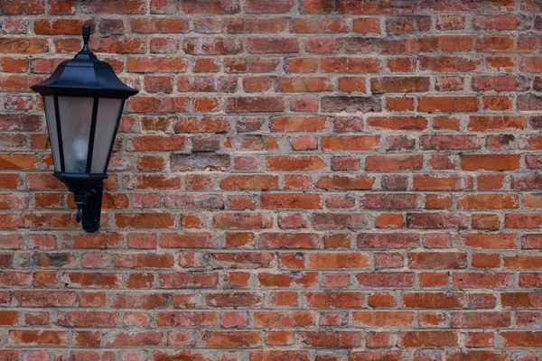 Classic outdoor lantern on red brick wall background. Copy space. — Stock Photo, Image