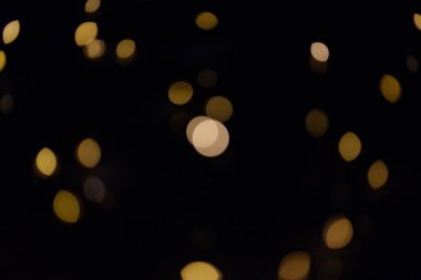 Altın bokeh daireler bir koyu arka plan, soyutlama, arka plan