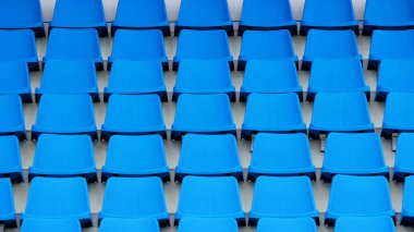 Stadyum standları boş plastik sandalyeler. Tribünlerde seyirci için çok boş koltuk. 