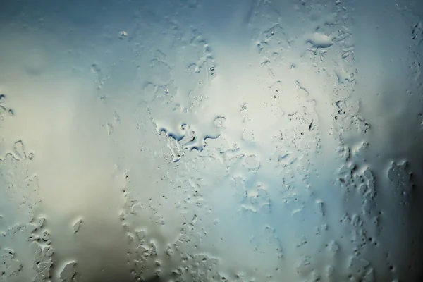 窗户上下着大滴雨。这是令人讨厌的一天。抽象的背景和纹理看起来像熔融金属 — 图库照片